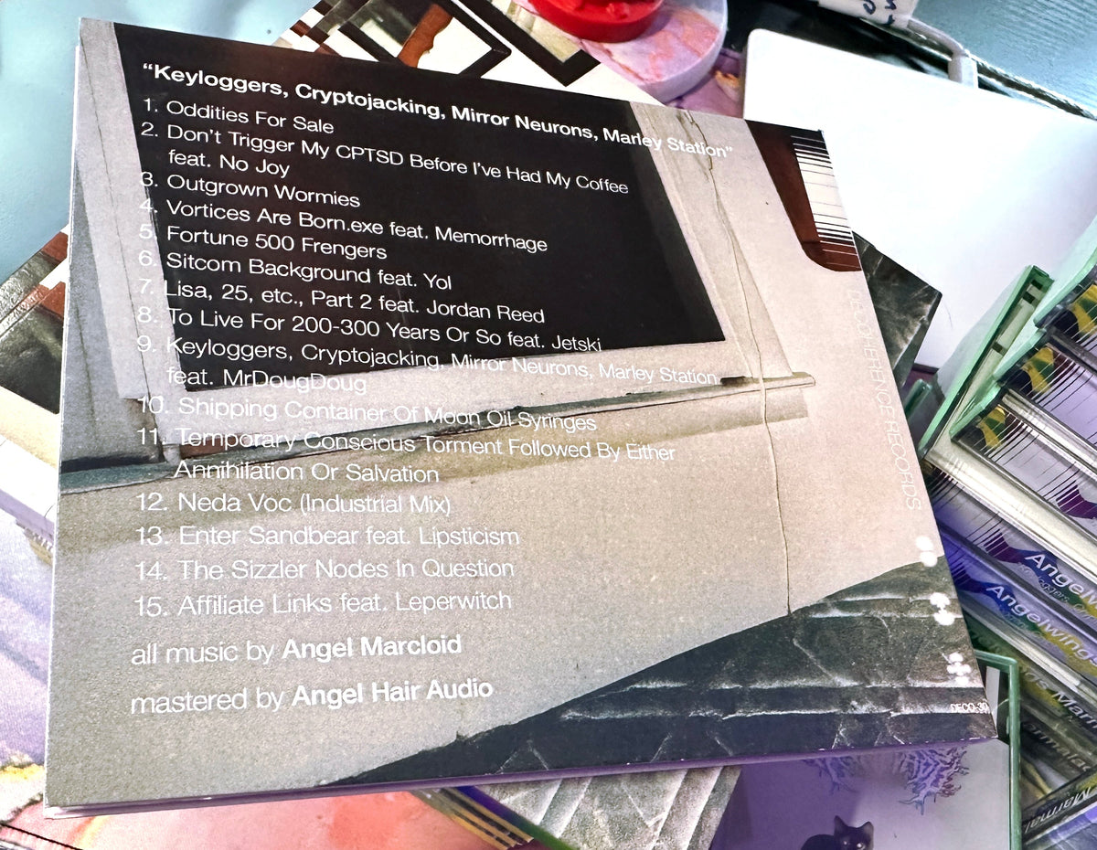 CDs with text surrounded by more CDs and packaging.