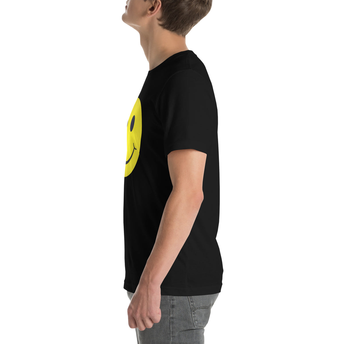 Person wearing a black t-shirt with a yellow smiley face design on a white background