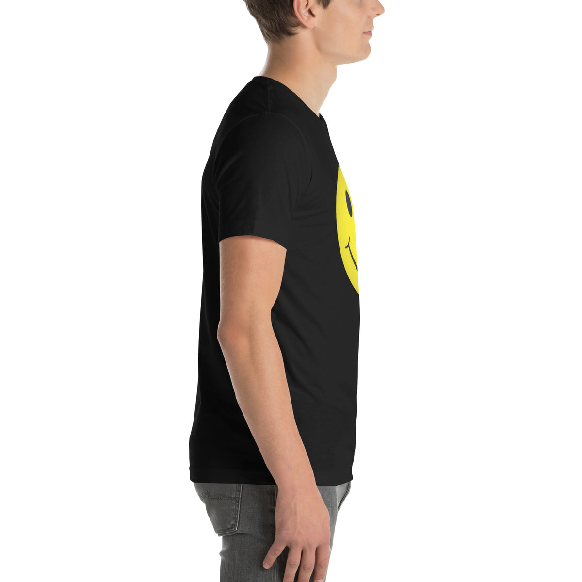Person wearing a black t-shirt with a yellow smiley face on a white background