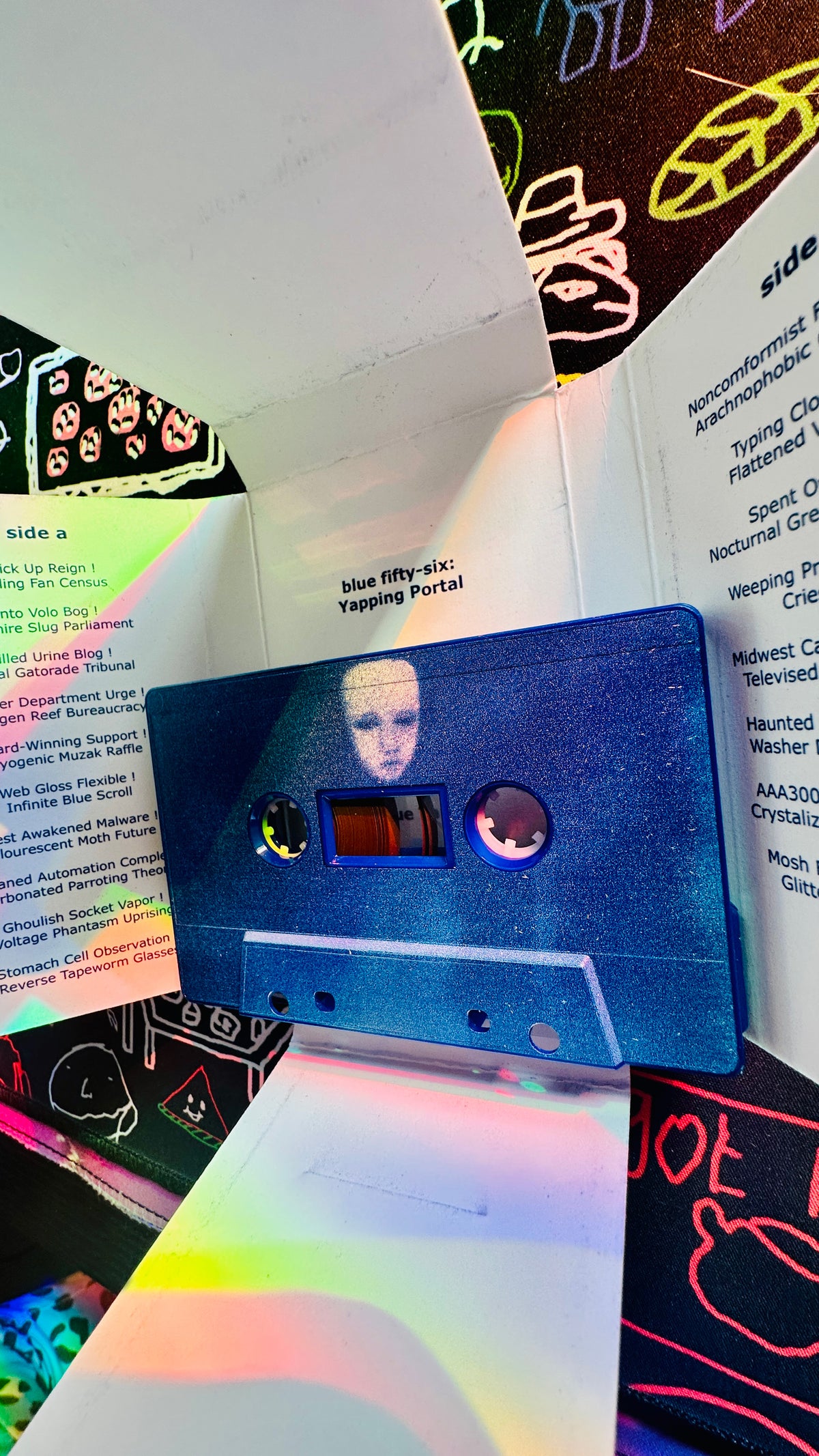 Blue Yapping Portal cassette & unraveled cassette box.